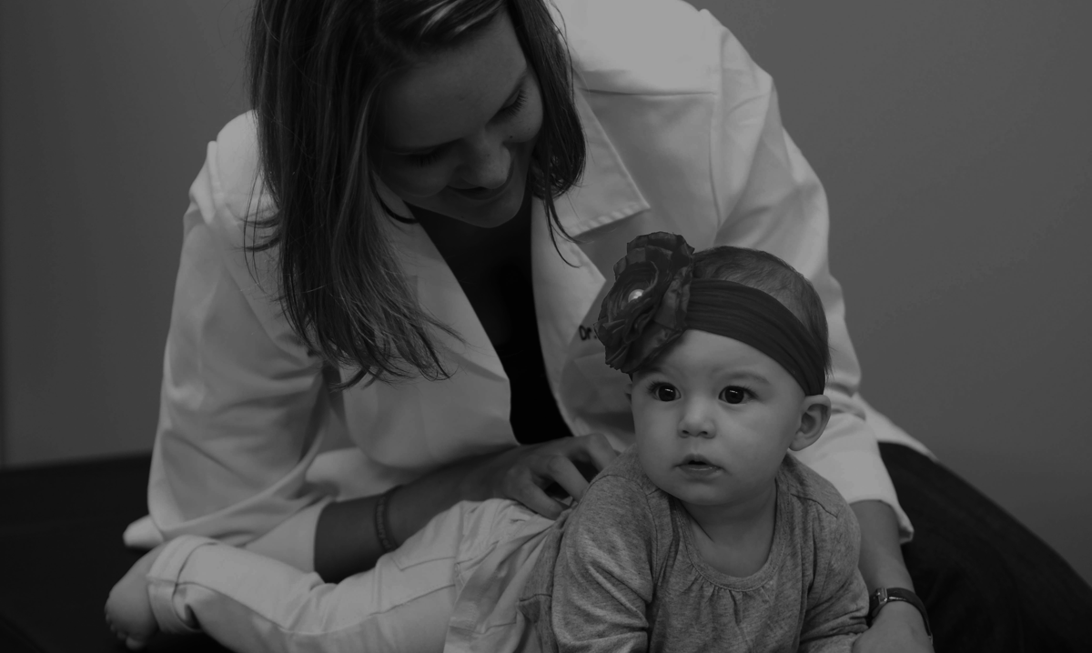Dr. Gomes examining an infant